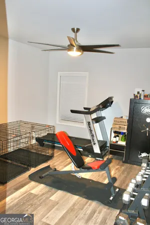a bedroom with double bunk beds and a ceiling fan