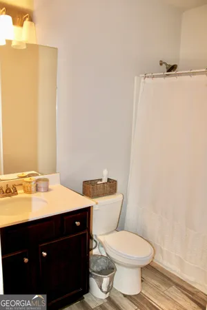 a bathroom with a sink vanity mirror and toilet