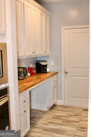 a kitchen with granite countertop white cabinets and white appliances