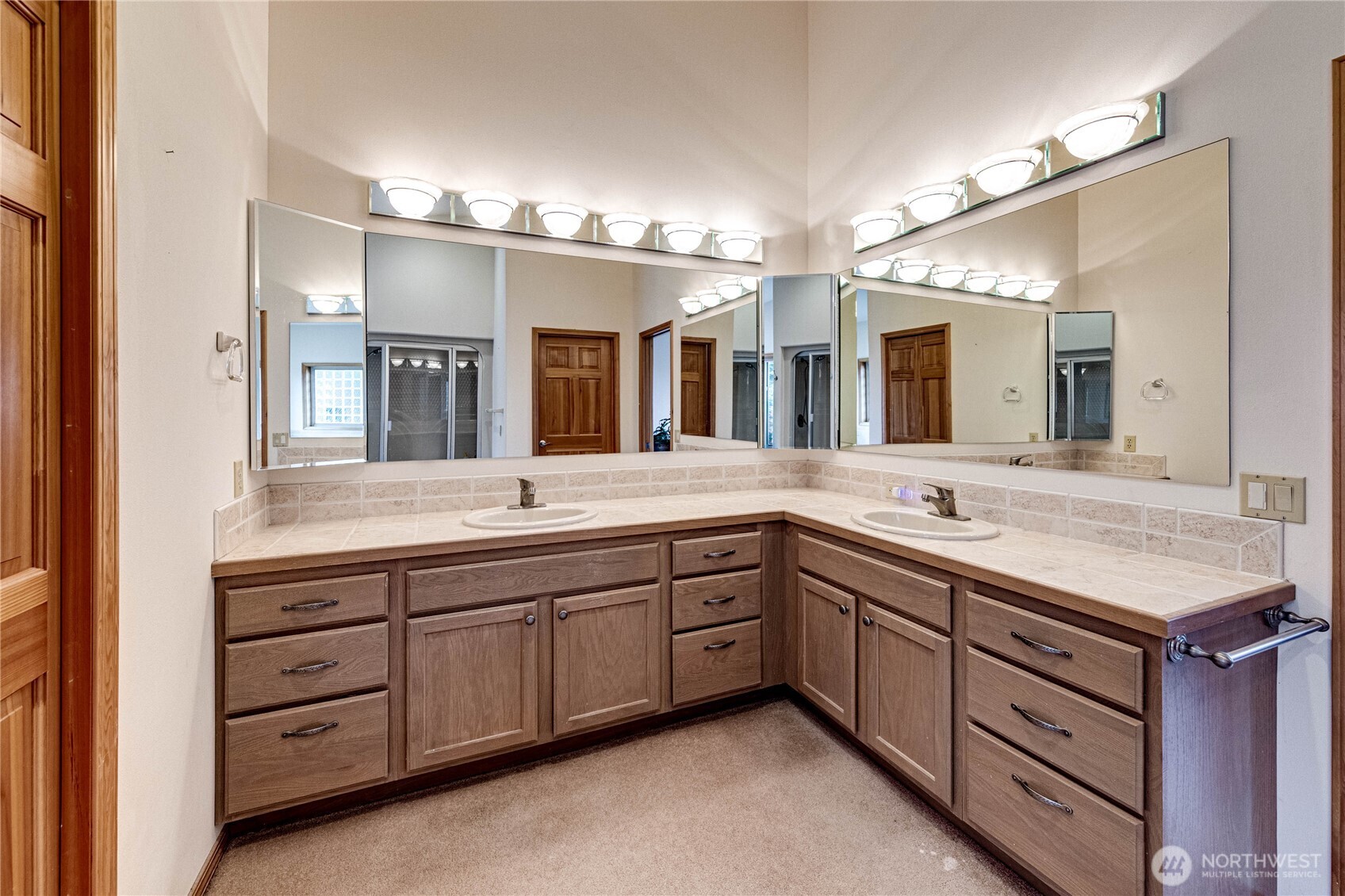 273 Harbor Heights Road Port Angeles, WA 98362 - Photo 26 of 40 a spacious bathroom with a granite countertop sink and mirror