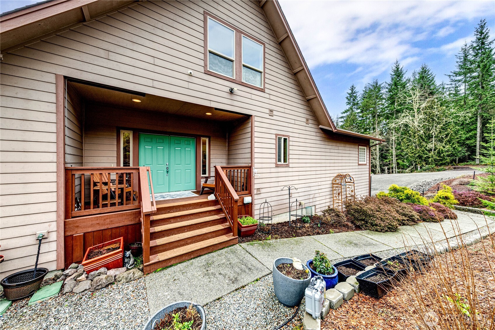 273 Harbor Heights Road Port Angeles, WA 98362 - Photo 6 of 40 a view of a chairs and tables in the back yard of the house