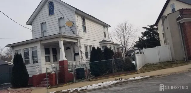 a view of a house with a wooden fence