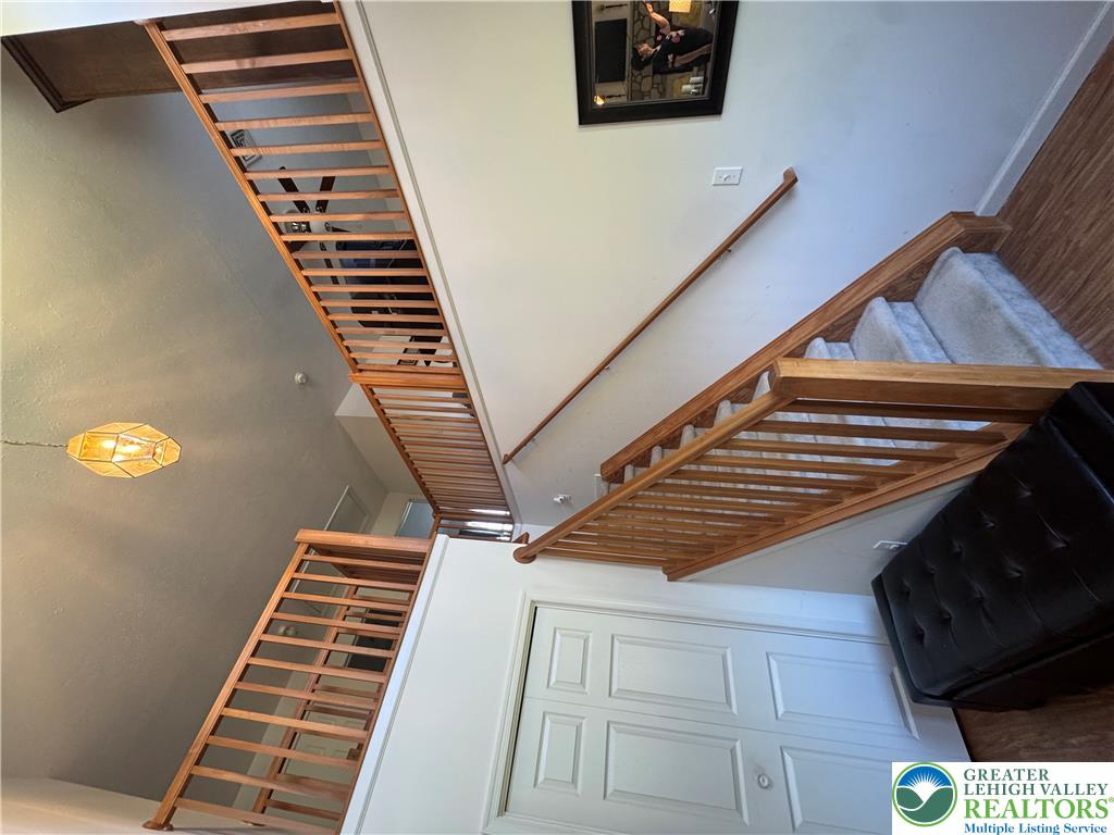 2742 Long Pond Road Long Pond, PA 18334 - Photo 19 of 57 An inviting entry reveals natural wood staircases with contrasting wall-to-wall carpeting and smooth handrails.