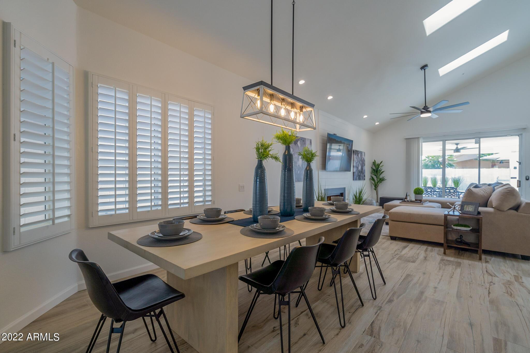 8661 East Gail Road Scottsdale, AZ 85260 - Photo 11 of 49 a view of a dining room with furniture and wooden floor