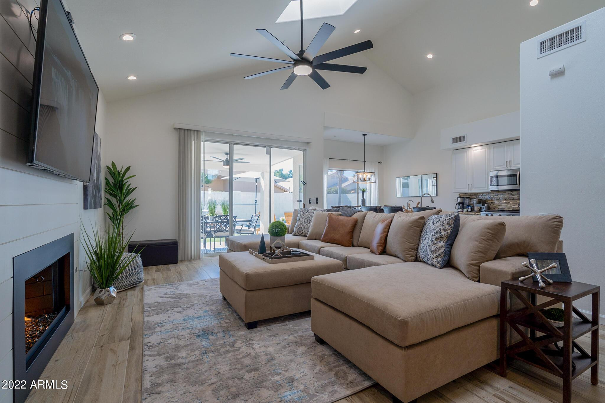 8661 East Gail Road Scottsdale, AZ 85260 - Photo 12 of 49 a living room with furniture flat screen tv and a fireplace