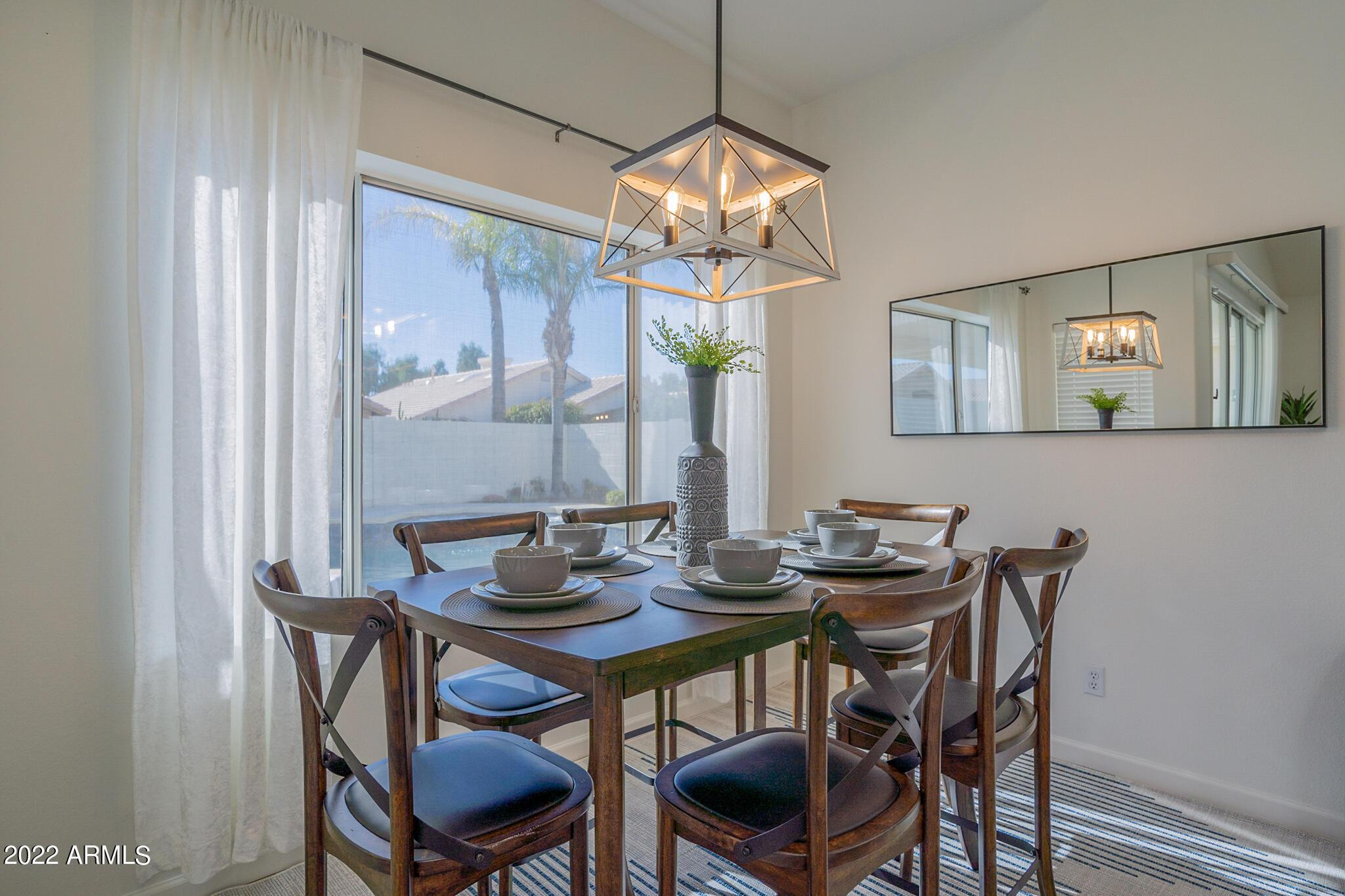 8661 East Gail Road Scottsdale, AZ 85260 - Photo 18 of 49 a view of a dining room with furniture and chandelier