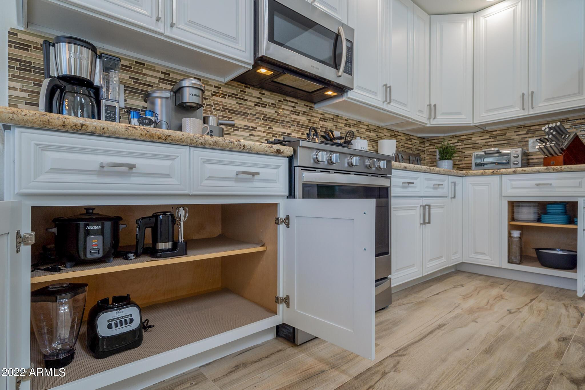 8661 East Gail Road Scottsdale, AZ 85260 - Photo 23 of 49 a kitchen with storage and utility