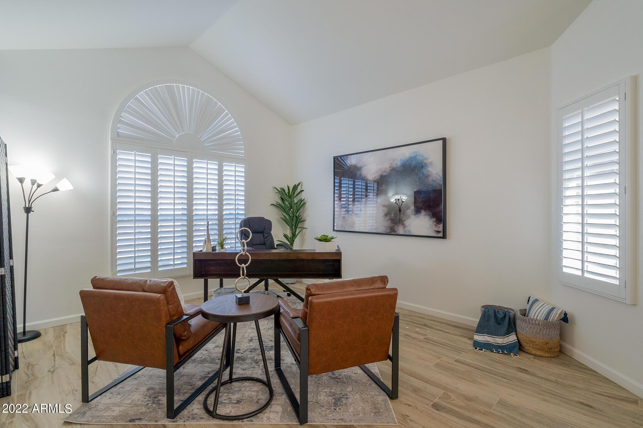 8661 East Gail Road Scottsdale, AZ 85260 - Photo 24 of 49 a living room with furniture a window and a chandelier