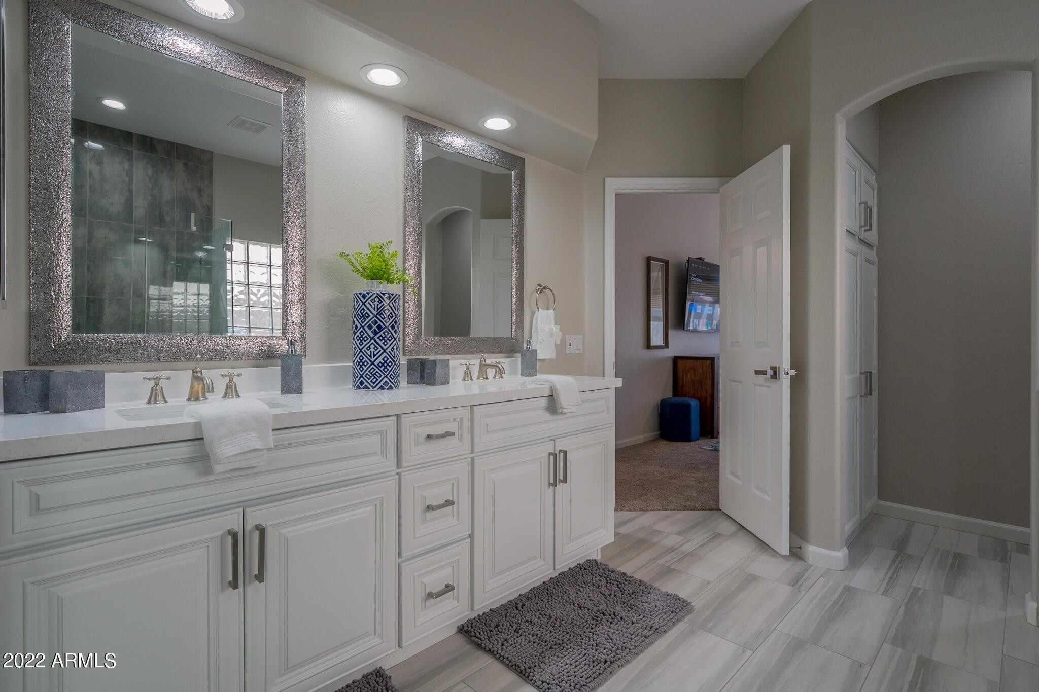 8661 East Gail Road Scottsdale, AZ 85260 - Photo 31 of 49 a spacious bathroom with a granite countertop sink a mirror and a