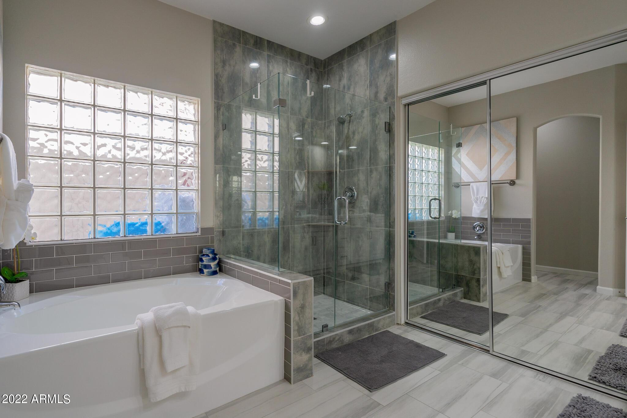8661 East Gail Road Scottsdale, AZ 85260 - Photo 32 of 49 a bathroom with a bathtub and a shower