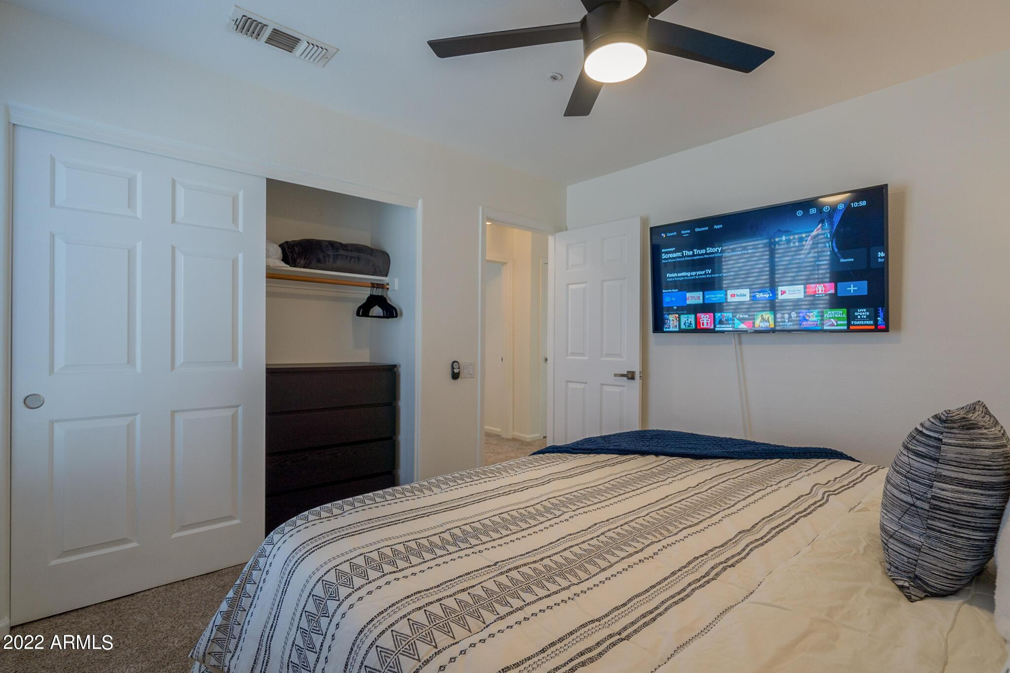 8661 East Gail Road Scottsdale, AZ 85260 - Photo 39 of 49 a bedroom with a bed and a chandelier
