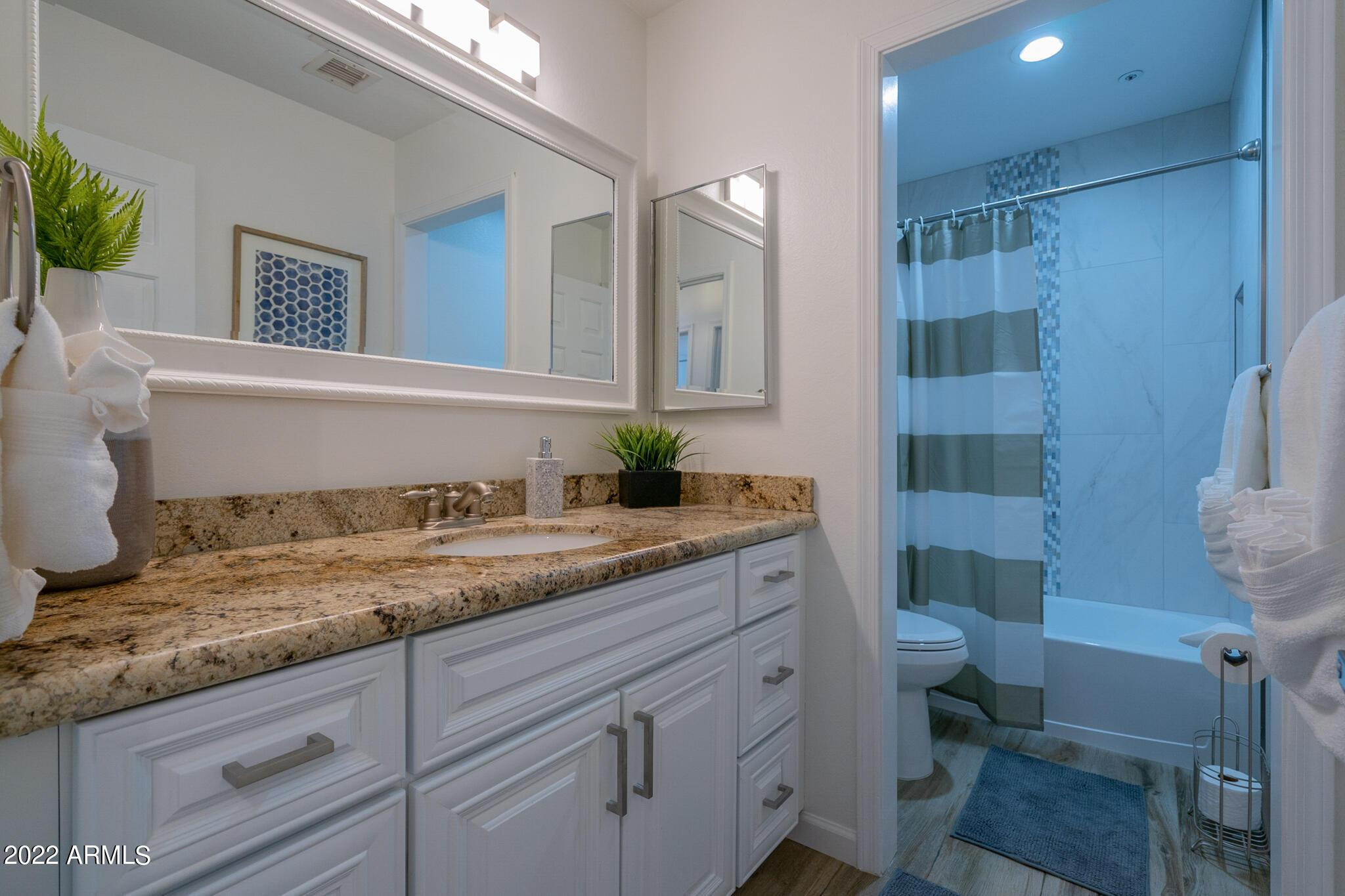 8661 East Gail Road Scottsdale, AZ 85260 - Photo 41 of 49 a bathroom with a granite countertop sink a toilet and shower