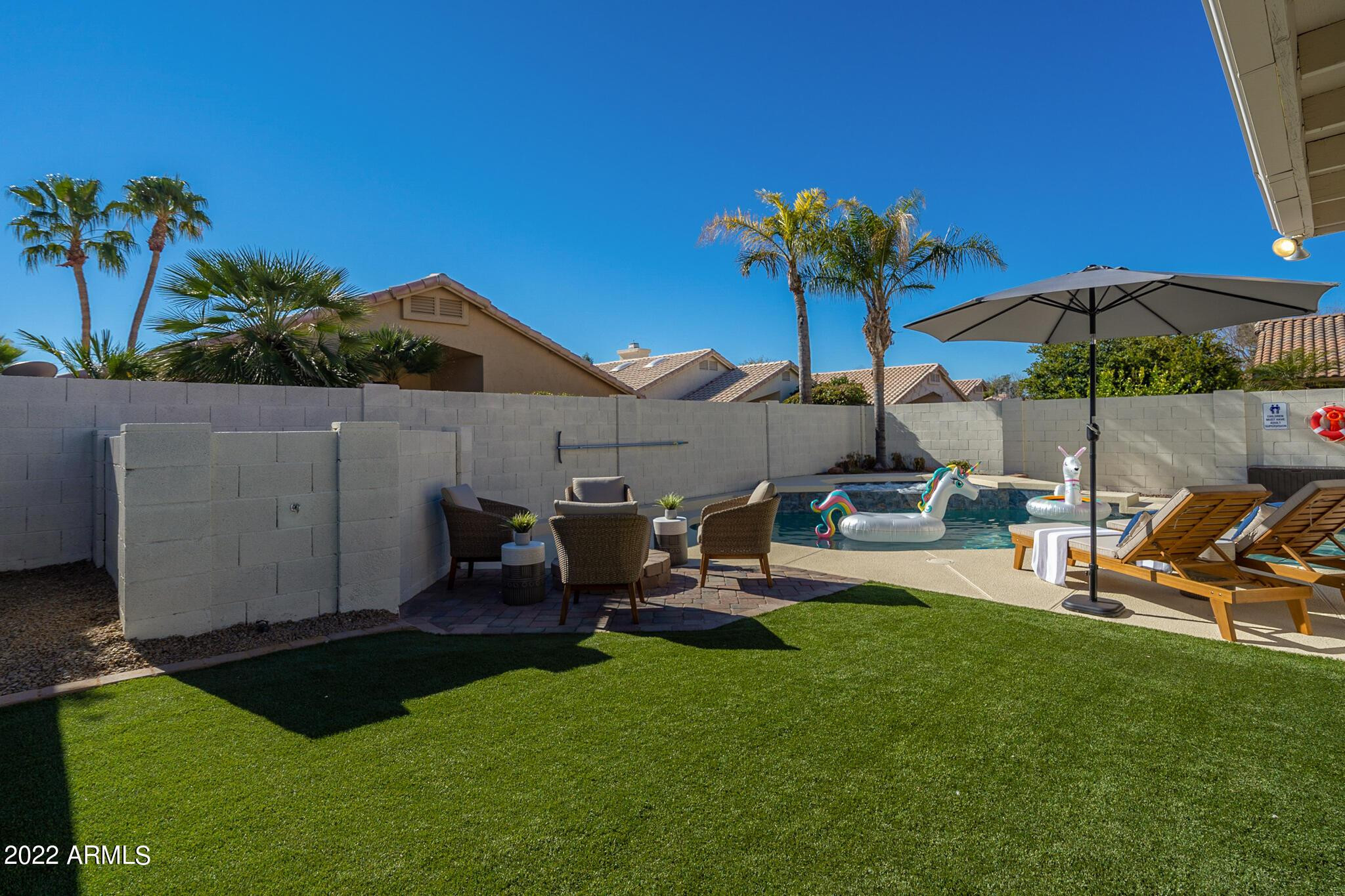 8661 East Gail Road Scottsdale, AZ 85260 - Photo 5 of 49 a view of a backyard with couches under an umbrella