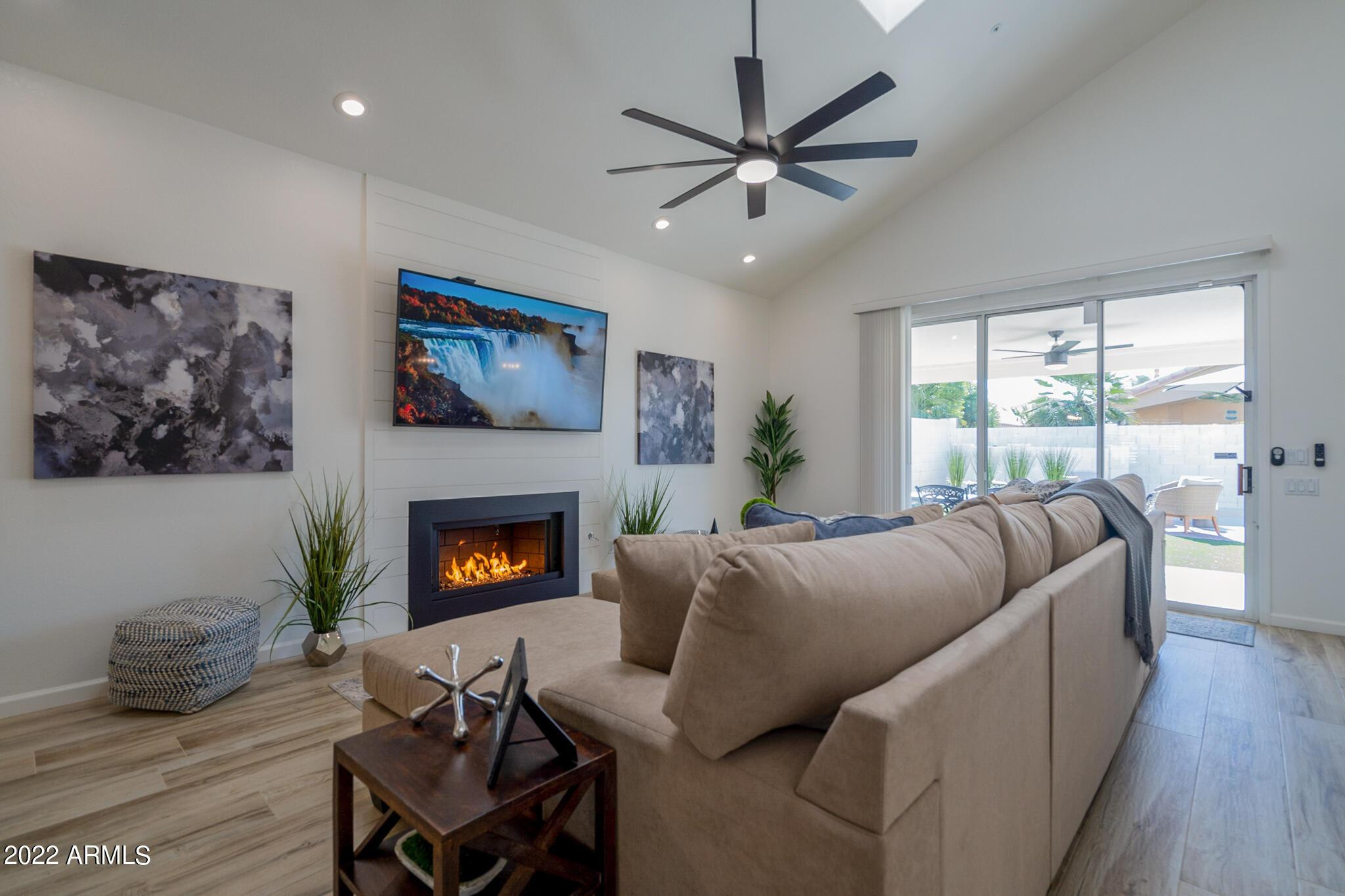 8661 East Gail Road Scottsdale, AZ 85260 - Photo 7 of 49 a living room with furniture and a fireplace