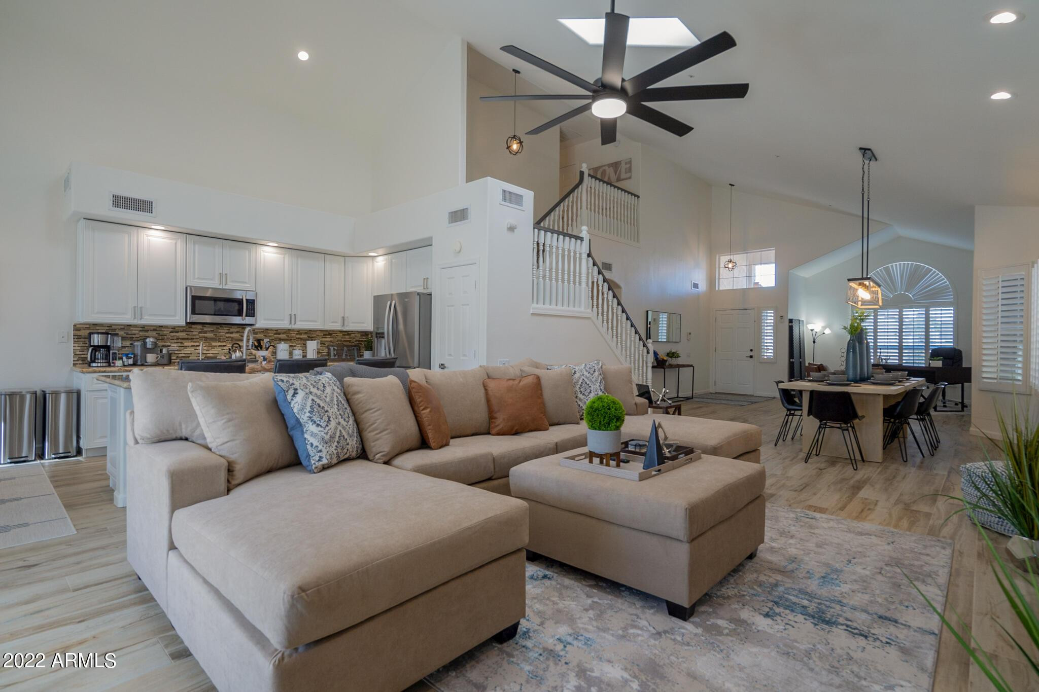 8661 East Gail Road Scottsdale, AZ 85260 - Photo 9 of 49 a living room with furniture kitchen view and a chandelier