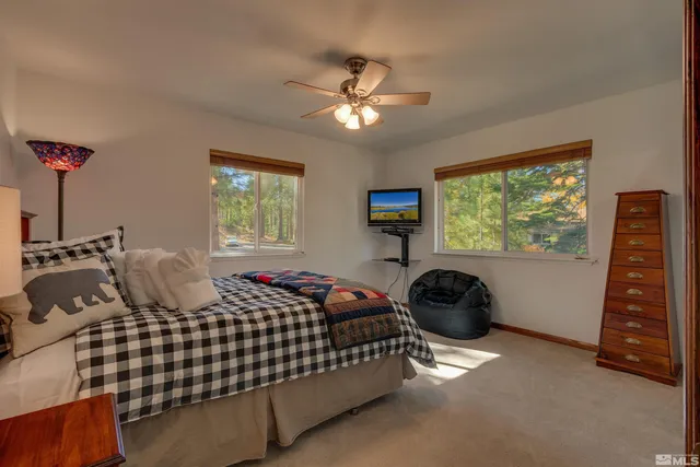 a bedroom with a bed and a large window
