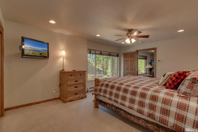 a bedroom with a bed and a ceiling fan