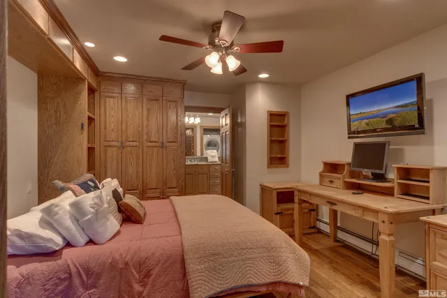 a bedroom with a large bed a desk and chair