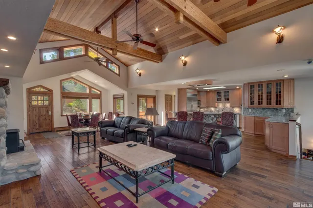 a living room with furniture a ceiling fan and a rug
