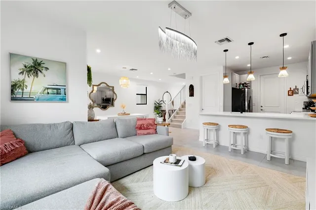 a living room with furniture and kitchen view