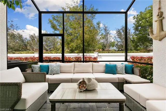 a living room with couch and a large window