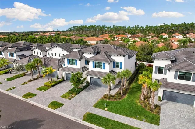 an aerial view of residential houses with yard