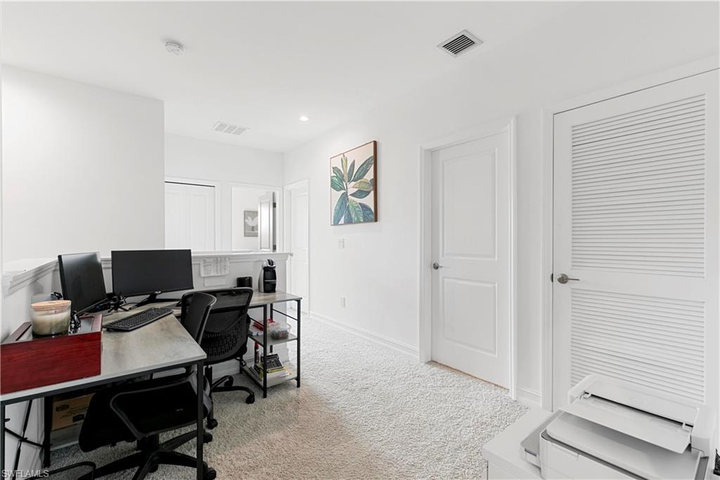 7578 Rockefeller Drive Naples, FL 34119 - Photo 22 of 39 a view of a workspace with furniture and a window