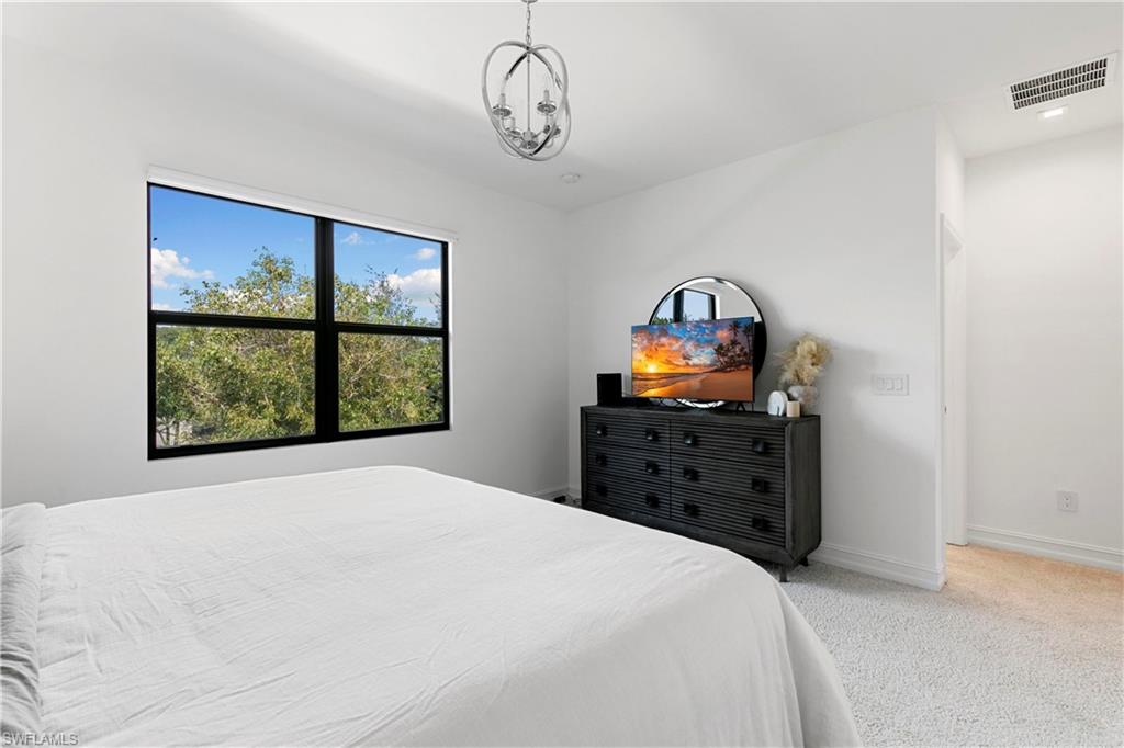 7578 Rockefeller Drive Naples, FL 34119 - Photo 23 of 39 a bedroom with a bed and a window