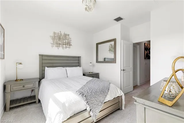 a bedroom with a bed and a night stand