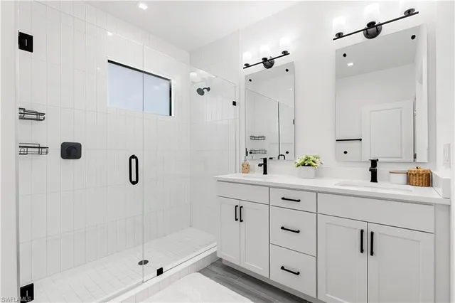a bathroom with a shower sink and mirror