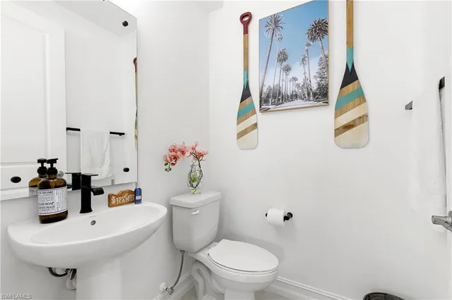 a bathroom with a sink mirror toilet and vanity