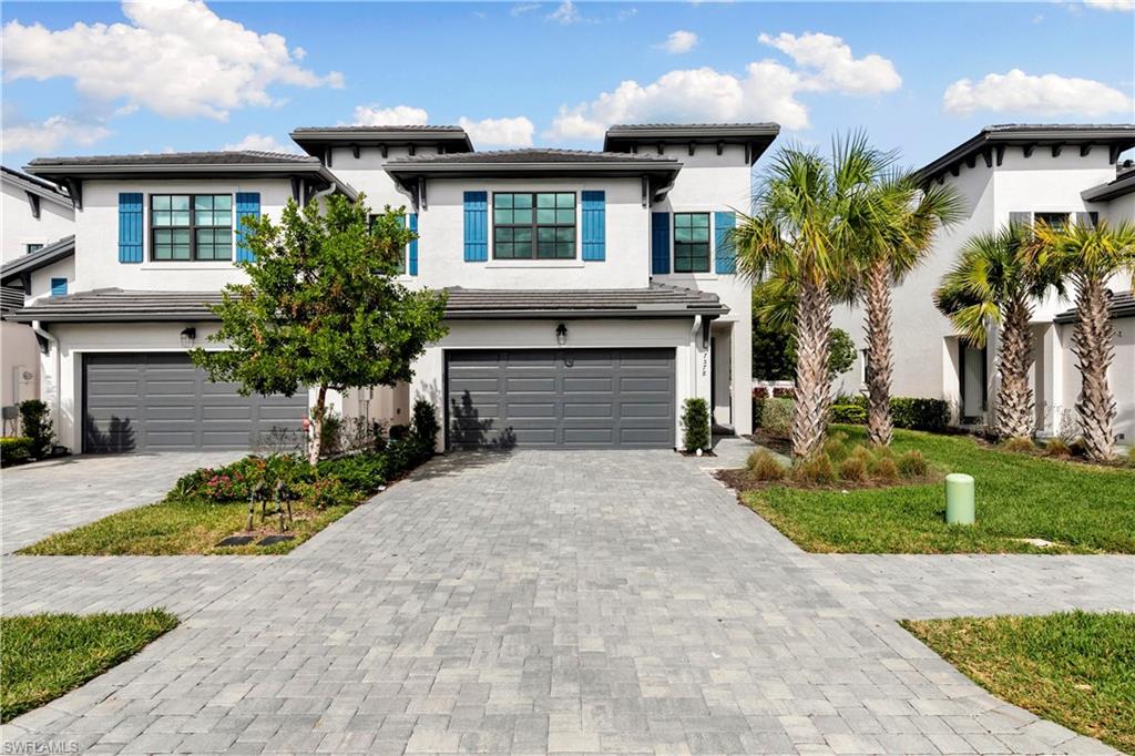 7578 Rockefeller Drive Naples, FL 34119 - Photo 32 of 39 a front view of a house with a yard and garage