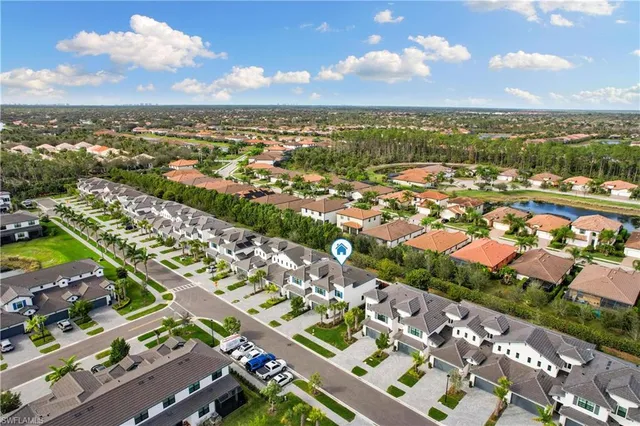 an aerial view of residential houses with outdoor space