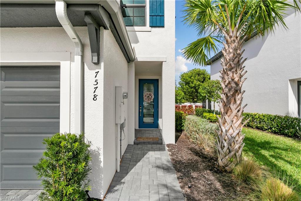 7578 Rockefeller Drive Naples, FL 34119 - Photo 4 of 39 a front view of a house with a yard