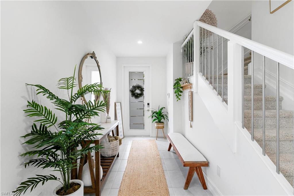 7578 Rockefeller Drive Naples, FL 34119 - Photo 5 of 39 a living room filled with furniture and a potted plant
