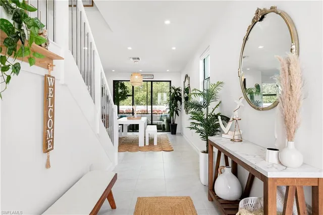 a living room with furniture and a mirror