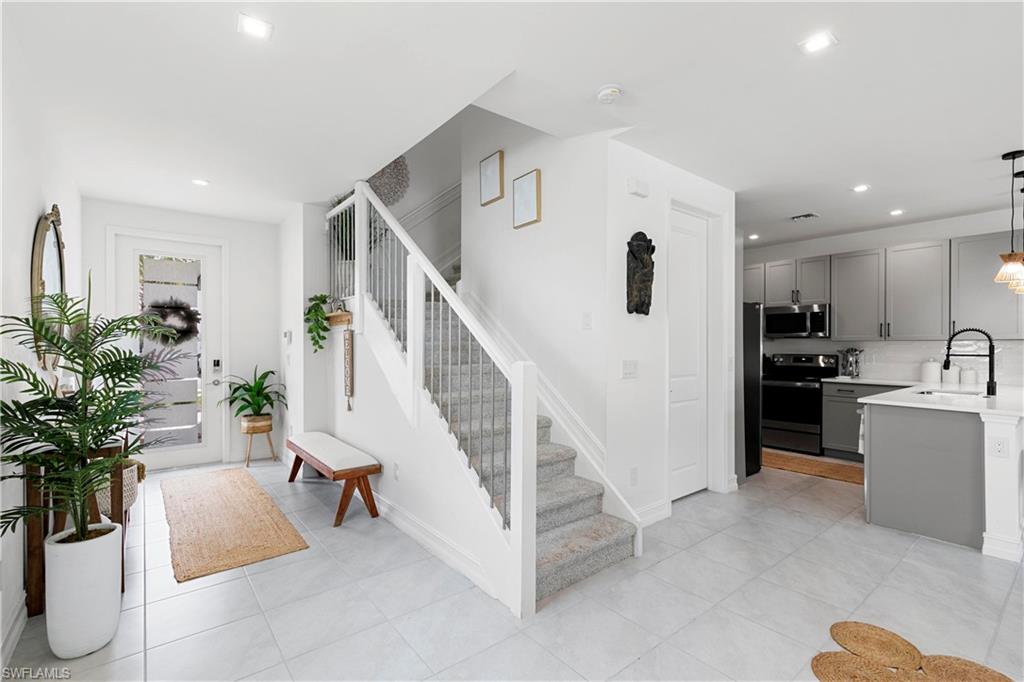 7578 Rockefeller Drive Naples, FL 34119 - Photo 7 of 39 a living room with furniture and a potted plant