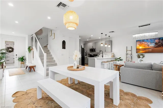 a living room with furniture and kitchen view