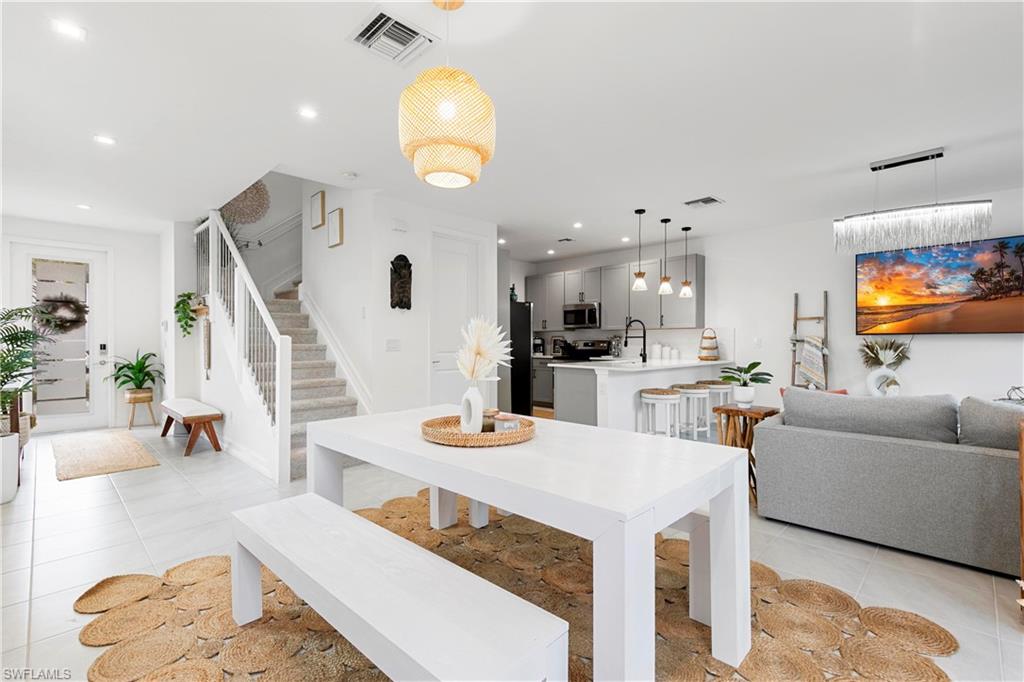7578 Rockefeller Drive Naples, FL 34119 - Photo 10 of 39 a living room with furniture and kitchen view