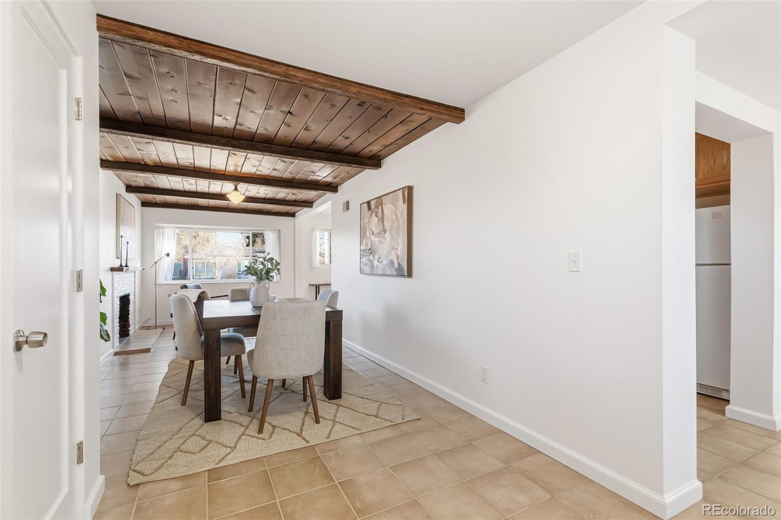 4535 Zephyr Street Wheat Ridge, CO 80033 - Photo 15 of 35 a dining room with furniture and a chandelier