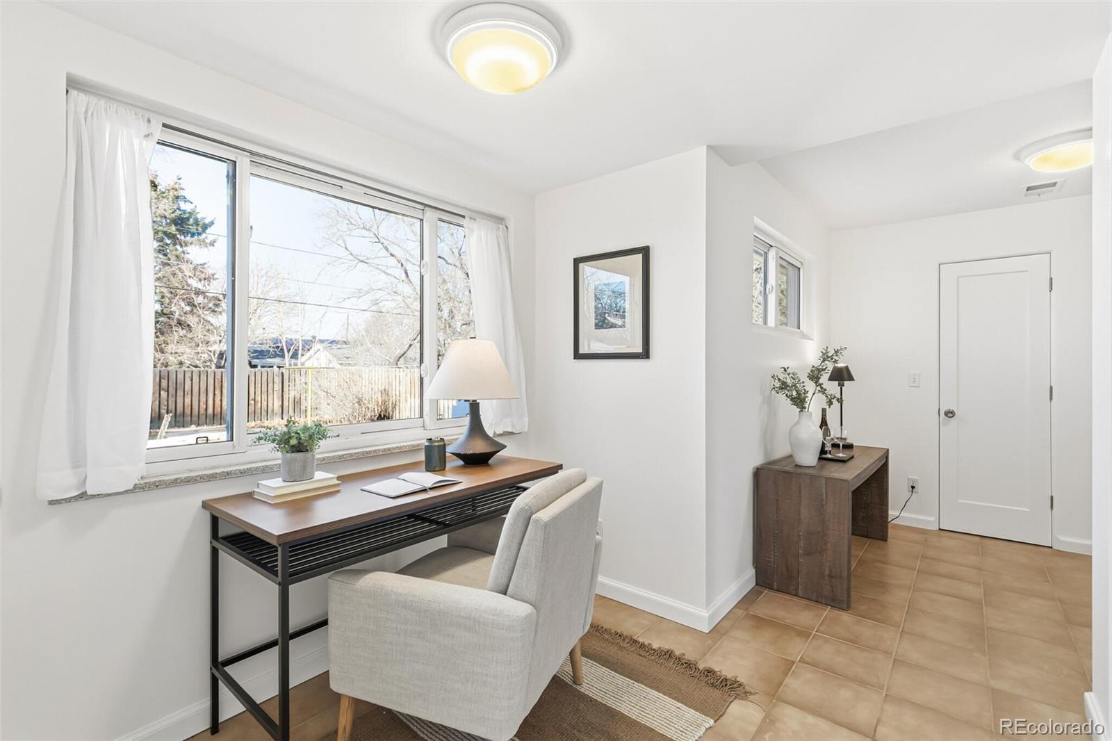 4535 Zephyr Street Wheat Ridge, CO 80033 - Photo 17 of 35 a view of a workspace with furniture and a window