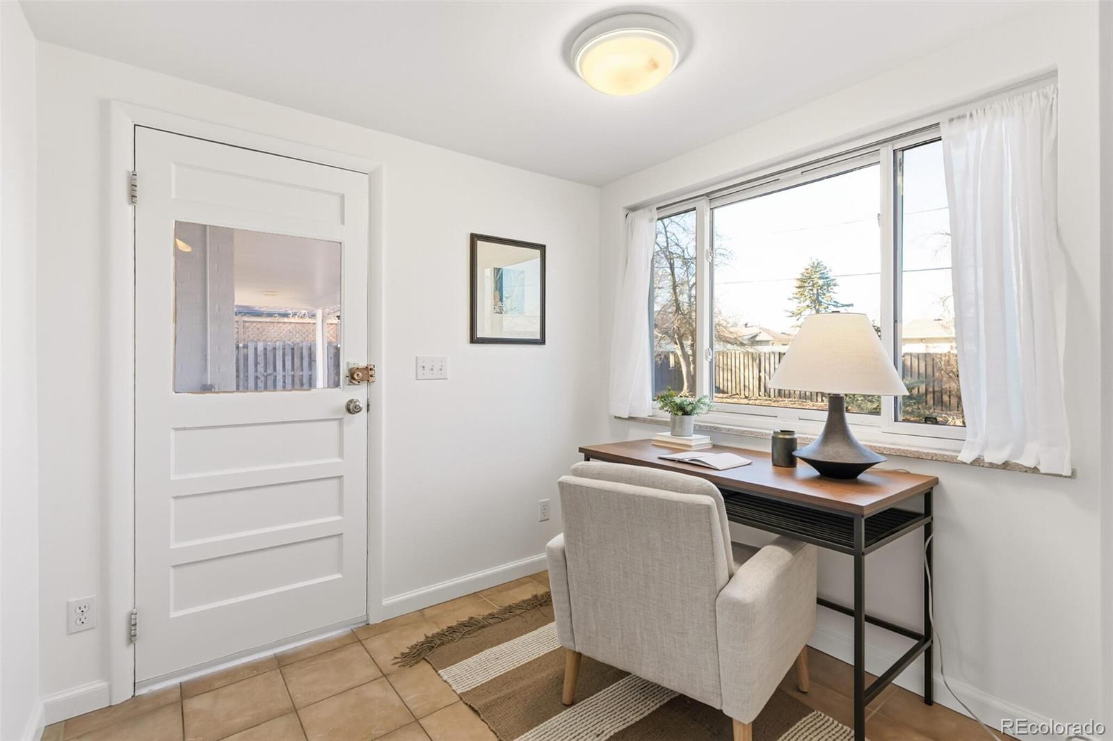 4535 Zephyr Street Wheat Ridge, CO 80033 - Photo 18 of 35 a view of a workspace with furniture and a window