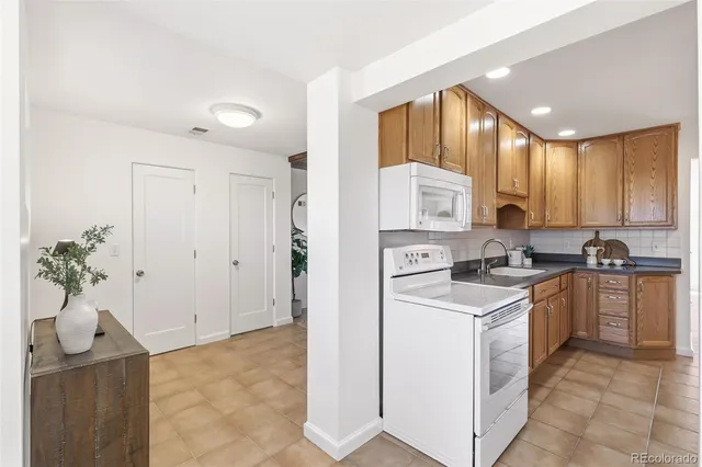 a kitchen that has a sink and a stove top oven