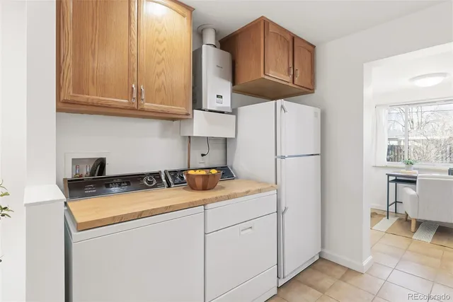 a kitchen with stainless steel appliances granite countertop a sink a stove a refrigerator and cabinets