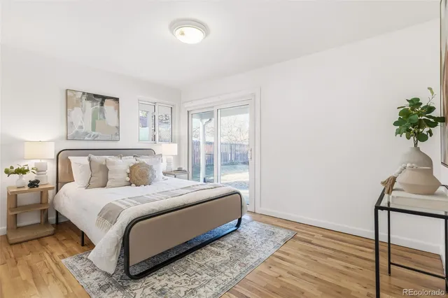a bedroom with a bed lamp and a potted plant