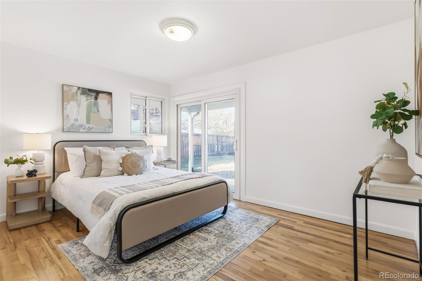 4535 Zephyr Street Wheat Ridge, CO 80033 - Photo 25 of 35 a bedroom with a bed lamp and a potted plant