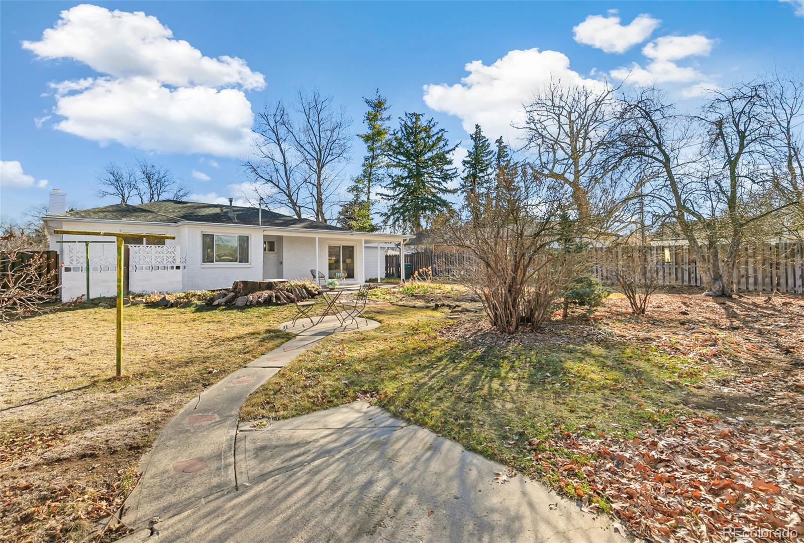 4535 Zephyr Street Wheat Ridge, CO 80033 - Photo 32 of 35 a view of a house with a yard