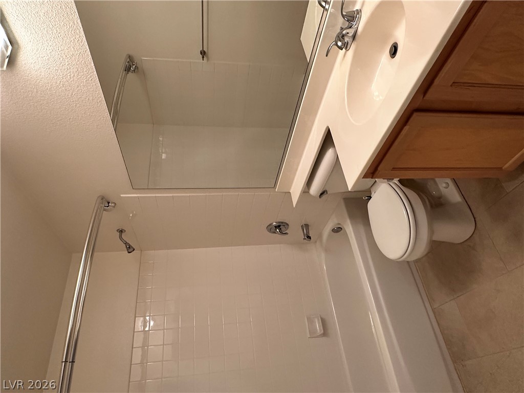 1922 Thunder Ridge Circle Henderson, NV 89012 - Photo 21 of 27 A well-appointed bathroom features a combined shower and tub, with a vanity and toilet.