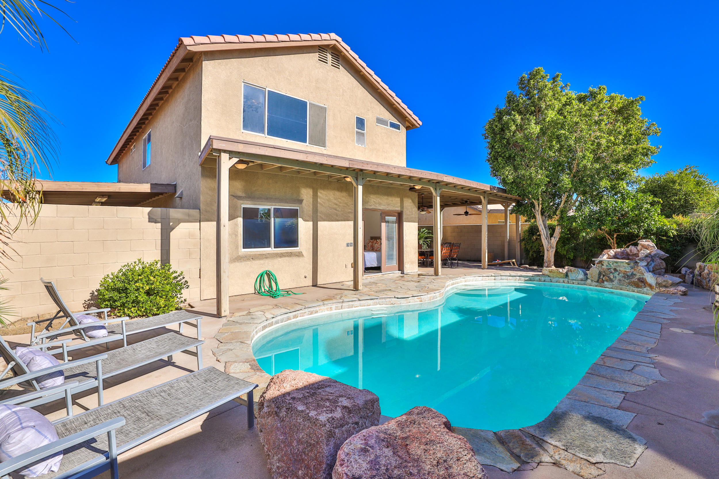 80721 Sycamore Lane Indio, CA 92201 - Photo 1 of 35 a view of house with swimming pool outdoor seating