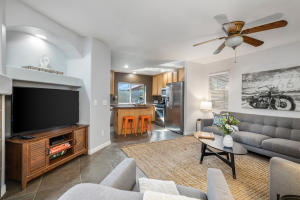 80721 Sycamore Lane Indio, CA 92201 - Photo 2 of 35 a living room with furniture and a flat screen tv with kitchen view